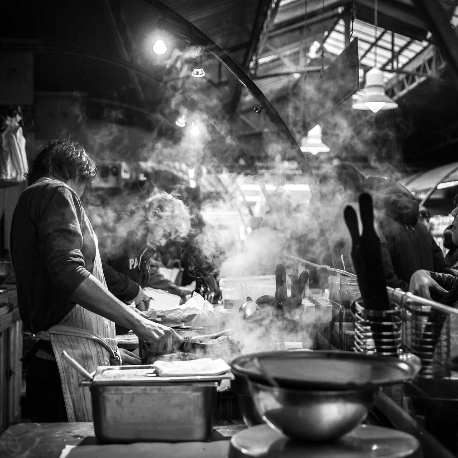 Community members collaborating in a modern kitchen space, sharing recipes and cooking techniques